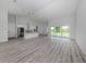 Spacious open-concept living room with wood flooring and sliding glass doors at 137 Mariner Ln, Rotonda West, FL 33947