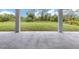 Covered patio with a view of a well-maintained lawn and beautiful trees at 137 Mariner Ln, Rotonda West, FL 33947
