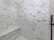 Shower clad in luxurious marble, including a built-in shower bench at 137 Mariner Ln, Rotonda West, FL 33947