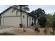 Inviting single-Gathering home with a two-car garage, stucco siding, and mature landscaping at 14261 Palm Ter, Port Charlotte, FL 33953