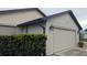 Single-Gathering home with a two-car garage and manicured bushes at 14261 Palm Ter, Port Charlotte, FL 33953