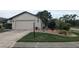Charming single-story home with a well-manicured lawn and attached two-car garage at 14261 Palm Ter, Port Charlotte, FL 33953