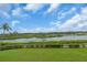 Lush backyard landscape with a tranquil river view, showcasing the beauty of the surrounding nature at 157 Tampa E Ave # 305, Venice, FL 34285