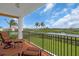 Balcony seating overlooks lush landscaping and tranquil waters, perfect for relaxation and outdoor enjoyment at 157 Tampa E Ave # 305, Venice, FL 34285