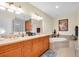 Luxurious bathroom featuring a soaking tub, double vanity, and ample lighting, perfect for relaxation and comfort at 157 Tampa E Ave # 305, Venice, FL 34285