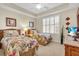 Charming bedroom with twin beds, neutral carpeting and tray ceiling at 157 Tampa E Ave # 305, Venice, FL 34285