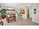 Bright dining area with a chandelier and bar seating, offering scenic views and modern updates at 157 Tampa E Ave # 305, Venice, FL 34285