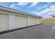 Attached garage units with white doors and red tiled roof at 157 Tampa E Ave # 305, Venice, FL 34285