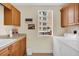 Bright laundry room with cabinets, countertop space, and modern washer and dryer at 157 Tampa E Ave # 305, Venice, FL 34285
