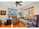 Cozy living room with natural light, comfortable seating, and a ceiling fan at 157 Tampa E Ave # 305, Venice, FL 34285