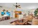Open floor plan with a kitchen, dining area, and living room, complete with a large TV at 157 Tampa E Ave # 305, Venice, FL 34285