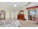 Bright bedroom with balcony access, showing dresser, and ceiling fan, offering a relaxing retreat at 157 Tampa E Ave # 305, Venice, FL 34285