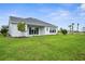 Beautiful home with a large lawn, backyard and a sleek gray roof at 18136 Foxtail Loop, Venice, FL 34293