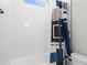 Bathroom with white subway tile, bathtub, shower curtain with a modern pattern and a toilet at 18136 Foxtail Loop, Venice, FL 34293