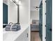 Bathroom featuring a double sink vanity, large mirror and a view to the main bedroom at 18136 Foxtail Loop, Venice, FL 34293