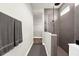 Bathroom featuring a large walk-in shower with glass enclosure, a large gray towel and a walk-in closet at 18136 Foxtail Loop, Venice, FL 34293