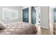 Bedroom view showcasing stylish teal doors, bright natural lighting, and sleek plank flooring at 18136 Foxtail Loop, Venice, FL 34293