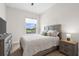 Bright bedroom featuring a large window, view to the outside, dresser, and coordinating nightstand at 18136 Foxtail Loop, Venice, FL 34293