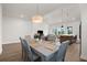 Bright dining room with seating for six, open to the kitchen and living room areas, great for entertaining at 18136 Foxtail Loop, Venice, FL 34293