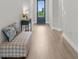 Inviting foyer with light wood flooring and a stylish bench, leading to an airy blue front door at 18136 Foxtail Loop, Venice, FL 34293