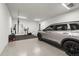 View of the spacious garage that includes a workout area and speckled floor at 18136 Foxtail Loop, Venice, FL 34293