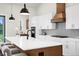 Modern kitchen featuring stainless steel appliances, stylish lighting, and a spacious center island at 18136 Foxtail Loop, Venice, FL 34293