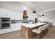 Bright, modern kitchen with a large island, stainless steel appliances, and an open layout to the dining area at 18136 Foxtail Loop, Venice, FL 34293