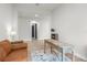 Bright living room with cozy seating, a rustic desk, and an open doorway at 18136 Foxtail Loop, Venice, FL 34293