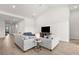 Bright and spacious living room with vaulted ceiling, featuring modern furnishings and light wood floors at 18136 Foxtail Loop, Venice, FL 34293