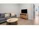 Cozy living room featuring a comfortable couch, TV, and stylish accents at 18136 Foxtail Loop, Venice, FL 34293