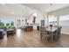 Open-concept living and kitchen space featuring a modern kitchen island with barstool seating and stainless appliances at 18136 Foxtail Loop, Venice, FL 34293