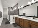 Luxurious primary bath with double vanity, sleek fixtures, and a walk-in shower at 18136 Foxtail Loop, Venice, FL 34293