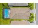 Aerial view of a home with screened pool, manicured lawn and mature trees at 19927 Bridgetown Loop, Venice, FL 34293