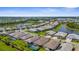 Aerial view of a residential community with lake views and a mix of single-Gathering homes at 19927 Bridgetown Loop, Venice, FL 34293