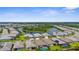 A beautiful aerial view of a well-maintained community with a central lake and lush landscaping at 19927 Bridgetown Loop, Venice, FL 34293