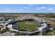Wide aerial view showcasing a well-maintained baseball stadium, surrounded by lush greenery and amenities in a thriving community at 19927 Bridgetown Loop, Venice, FL 34293