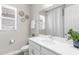 Bathroom showing white vanity and sink, with window and toilet at 19927 Bridgetown Loop, Venice, FL 34293