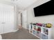 Bedroom showing ceiling fan, a mounted TV, and a closet for storage at 19927 Bridgetown Loop, Venice, FL 34293