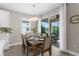 Dining area features sliding glass doors leading to an outdoor patio, filling the space with natural light at 19927 Bridgetown Loop, Venice, FL 34293