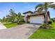 Charming single-Gathering home with tile roof, two car garage, and manicured landscaping at 19927 Bridgetown Loop, Venice, FL 34293