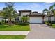 Charming single-story home with lush landscaping and a brick-paved driveway at 19927 Bridgetown Loop, Venice, FL 34293
