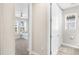 Hallway leading to bedroom, showing closet door and a bathroom at 19927 Bridgetown Loop, Venice, FL 34293