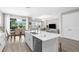 Open-concept kitchen with island flowing into the living and dining areas, creating a bright and airy space at 19927 Bridgetown Loop, Venice, FL 34293