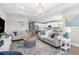 Bright living room featuring neutral decor, a stylish rug, and open layout at 19927 Bridgetown Loop, Venice, FL 34293