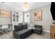 Stylish living room with gray sectional sofa, hardwood floors, and elegant chandelier at 19927 Bridgetown Loop, Venice, FL 34293