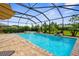 Backyard boasts a private pool and spa, surrounded by lush landscaping for a relaxing outdoor oasis at 19927 Bridgetown Loop, Venice, FL 34293