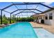 Screened-in pool area with water features and ample space for lounging and entertaining at 19927 Bridgetown Loop, Venice, FL 34293