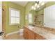 Bathroom with granite countertop vanity and a shower with tiled walls at 20169 Cristoforo Pl, Venice, FL 34293