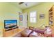 Bedroom with wood floors, ceiling fan, leather chair, and bookshelf at 20169 Cristoforo Pl, Venice, FL 34293