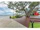 Relaxing lakeside space with wooden deck and mature trees, perfect for community gatherings at 20169 Cristoforo Pl, Venice, FL 34293
